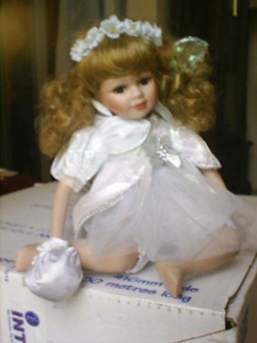 PORCELAIN DOLL IN SIT POSITION