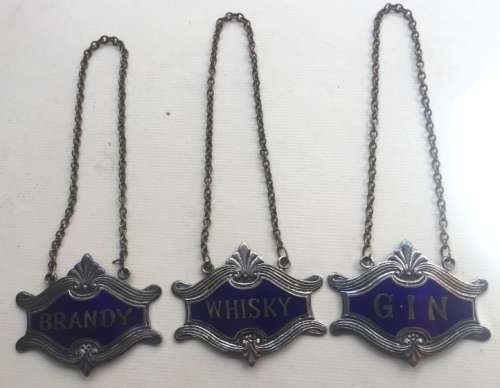 VINTAGE WHISKY, BRANDY and GIN DECANTER , ENAMELED BRASS NECK TAGS