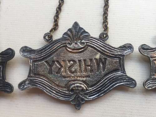 VINTAGE WHISKY, BRANDY and GIN DECANTER , ENAMELED BRASS NECK TAGS