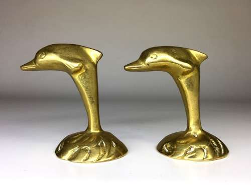 A  MATCHED PAIR  OF SOLID BRASS, DOLPHIN  ORNAMENTS