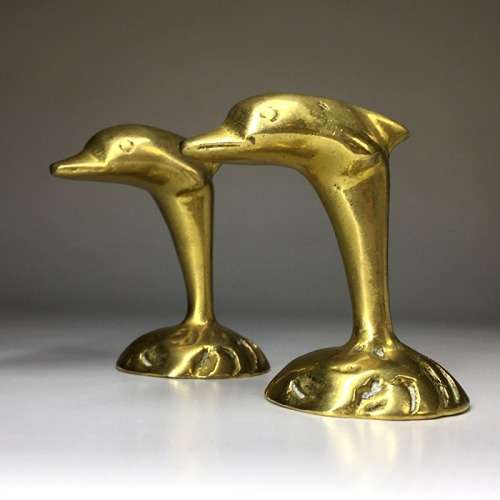 A  MATCHED PAIR  OF SOLID BRASS, DOLPHIN  ORNAMENTS