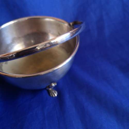 Silver plated bowl with 3 shell legs and handle