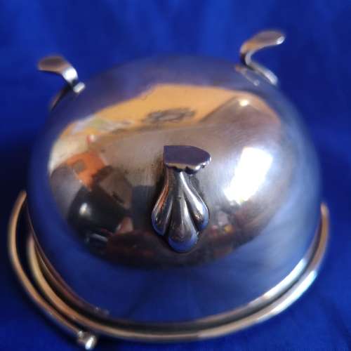 Silver plated bowl with 3 shell legs and handle