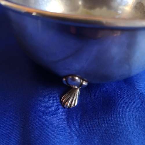 Silver plated bowl with 3 shell legs and handle