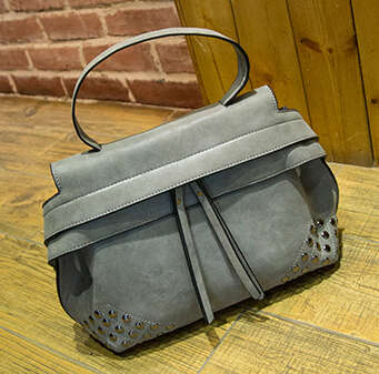 Tassels and rivets fashion ladies handbag with strape. Grey color. Stock in ZA