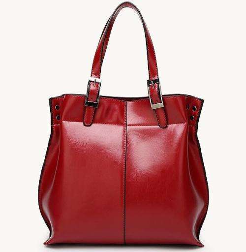Beautiful elegant Tote style ladies handbag, with strap. Maroon color. Stock in South Africa