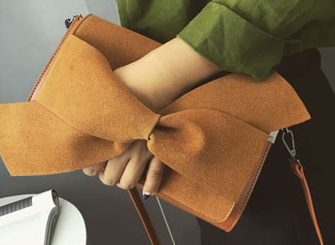 Nubuck bowknot clutch. Brown color. Stock in ZA.