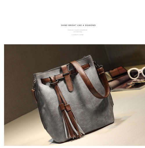 Fashion bucket ladies bag with tassels. Grey color. Stock in ZA.