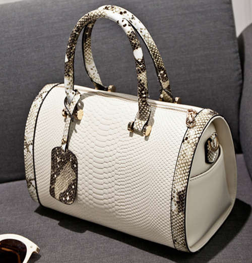 Snake pattern pillow shape handbag. White color. Have a strape