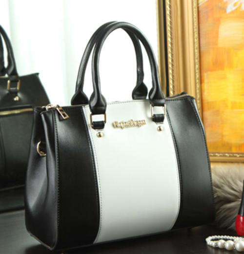 Classic colors joint office ladies handbag with strape. Black matches white. Stock in ZA