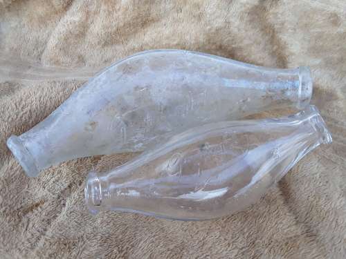 Two antique embossed glass baby feeding bottles Griptight