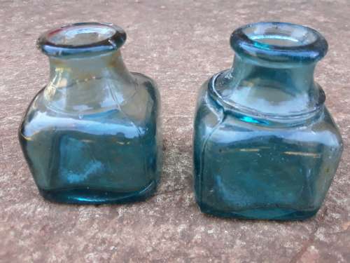 Two teal green ink bottles