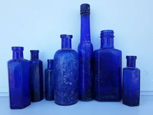 Seven antique and vintage blue bottles