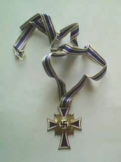 Genuine German Mothers Cross. Initialed & signed 16 December 1938. Slight damage to enamel.