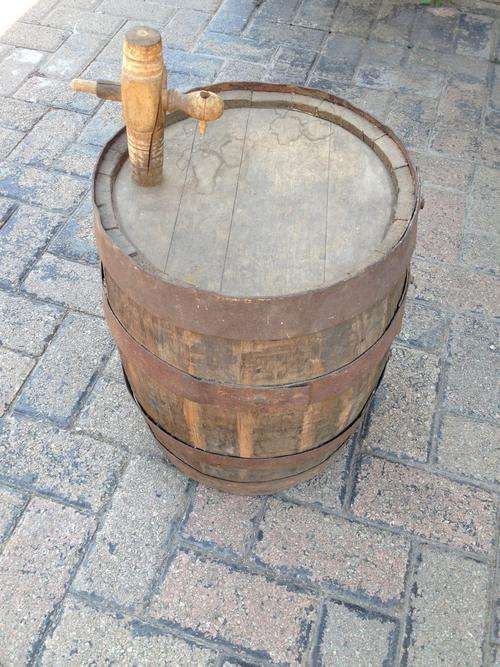Old handcrafter small wooden barrel with handcrafted tap