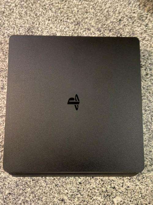 PLAYSTATION SLIM 1 TB WITH 2 CONTROLLERS and 1 GAME
