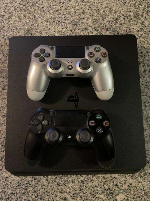 PLAYSTATION SLIM 1 TB WITH 2 CONTROLLERS and 1 GAME