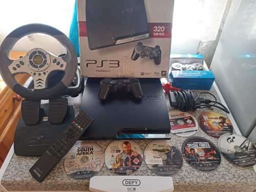 PS3 SLIMLINE EDITION 320GB WITH STEERING WHEEL  AND 7 ORIGINAL DISC GAMES WITH,AND 25GAMES LOADED