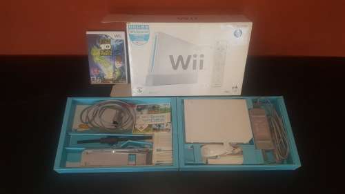 Nintendo Wii with two games, sensor bar, Wii controller and nunchuk and stand for Wii