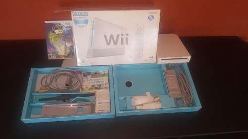 Nintendo Wii with two games, sensor bar, Wii controller and nunchuk and stand for Wii