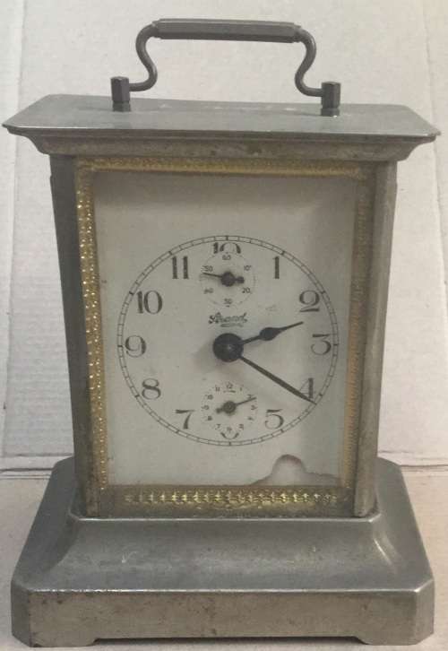 An unusual brass alarm clock with a musical movement....all not working