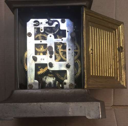 An unusual brass alarm clock with a musical movement....all not working