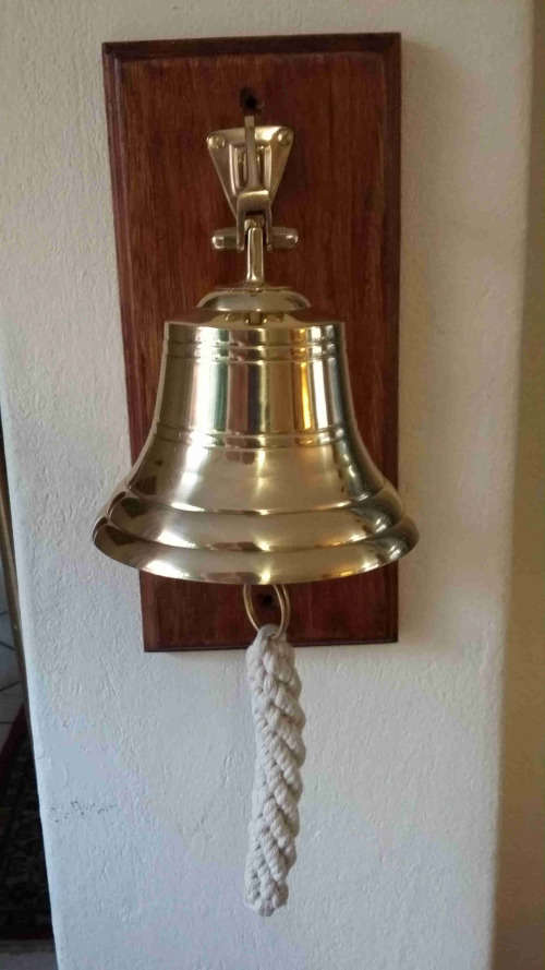 Solid brass ship, motivational bell 11.5cm diameter, sales bell. Wall mounted on solid wood