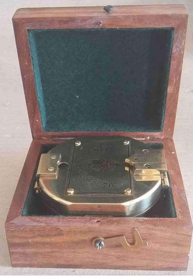 Brunton hexagonal heavy solid brass compass .