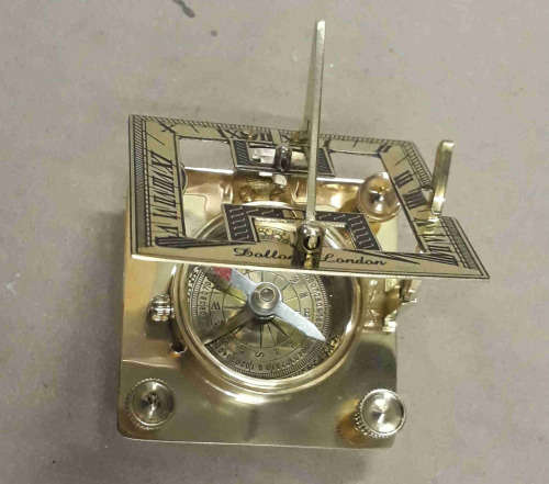Brass sundial compass in a wooden glass box