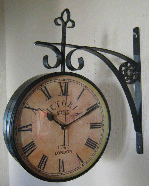 Clock. Victoria station double sided wall mounted clock