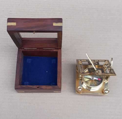 Brass sundial compass in a wooden glass box