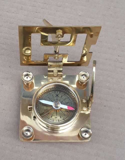Brass sundial compass in a wooden glass box