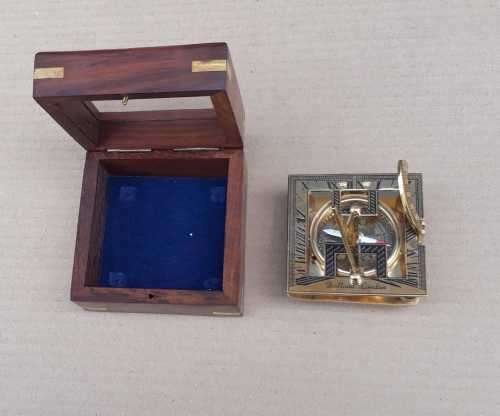 Brass sundial compass in a wooden glass box
