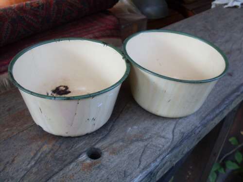 A PAIR OF SMALL DEEP CHARACTERFUL CREAM WITH GREEN TRIM ENAMEL BOWLS MARKING DIAMOND