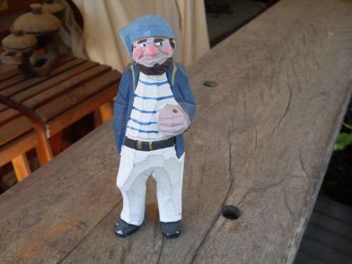 CARVED PAINTED WOODEN ORNAMENT OF A FISHERMAN OR SAILOR