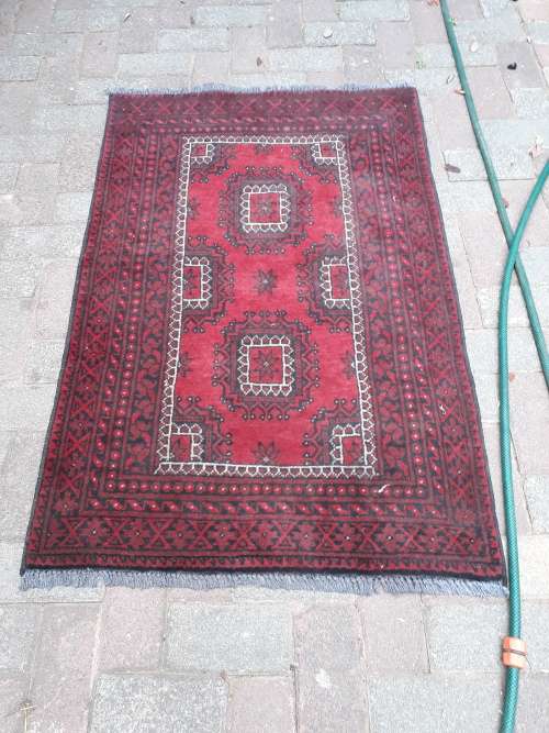 NICE SIZE AFGHAN RUG. TYPICAL GEOMETRIC, FLORAL ETC, REDS BLACK IVORY GREY FRINGE ETC GOOD CONDITION