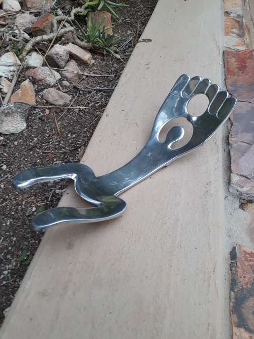 LIKE "CARROL BOYES"KALEIDOSCOPE DESIGNS MAN WITH LARGE HANDS WINE BOTTLE HOLDER. NICE TABLE DECOR!