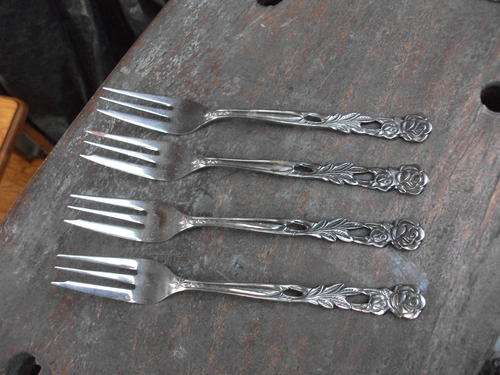 WOULD THINK VINTAGE. A SET OF FOUR ROSE FLOWER DETAILED S/S MADE IN JAPAN FORKS. LOVELY!