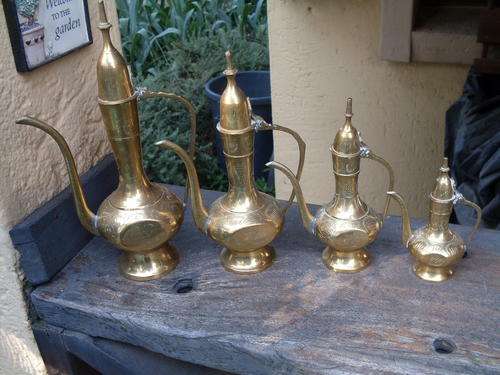 A LOVELY SET OF GRADUATING (X 4) MOROCCAN TURKISH OR INDIAN BRASS KETTLES CHASED DESIGN