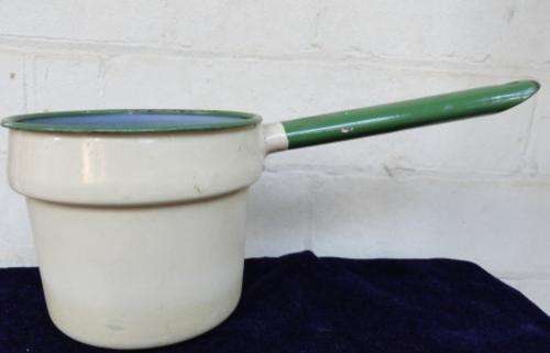 A single cream bowler pot with green edging on rim and handle.