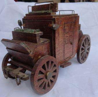 A handcrafted vintage music box designed as a stage coach.Made of oak?