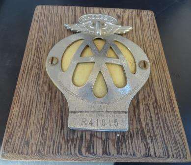 A vintage RHODESIAN  AA badge on a wooden plinth