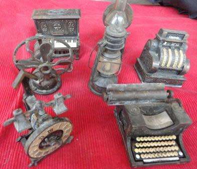 A  collection of seven pencil sharpeners designed as vintage items.