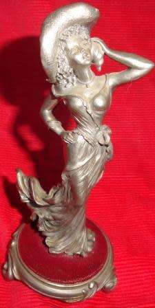 A metal figurine of lady -deco style