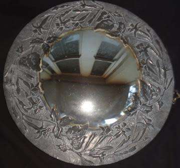 A vintage circular pewter mirror
