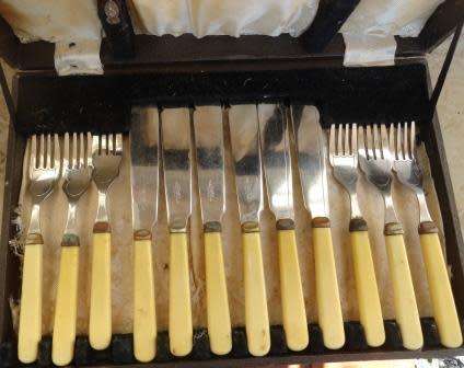 A vintage boxed fish set : six knives and six forks-bone handled. Made in Sheffield.