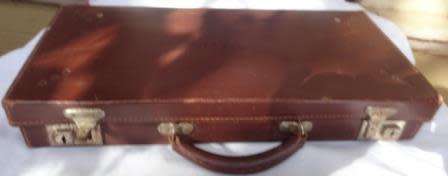 A vintage genuine leather case with  maroon velvet inlay