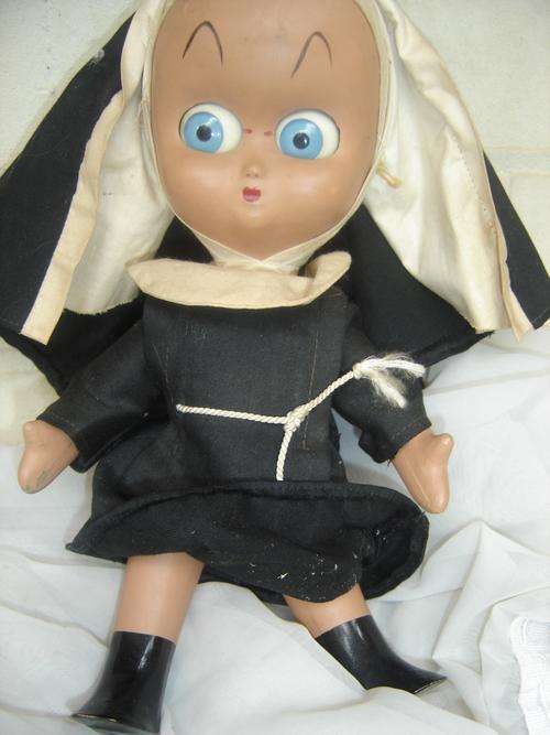 Unusual nun doll with the most striking blue eyes.
