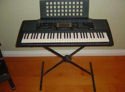 Yamaha PSR 420 keyboard on stand. Includes manual.