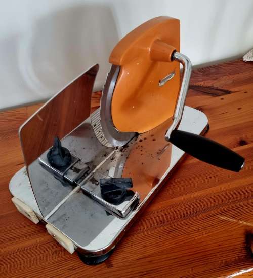 Orange enamel and steel retro bread slicer